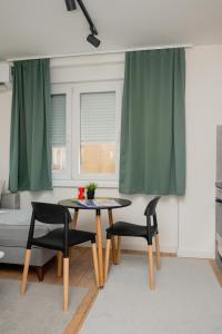 a living room with a table and two chairs at Ali-pasha luxury apartment in Sarajevo