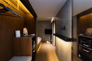 a hotel room with a bed and a tv at Guwol Hotel in Seoul