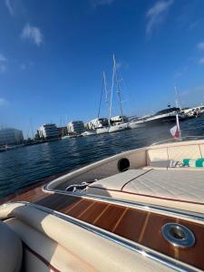 a boat on the water with other boats in the background at Sopot Classic Boat in Sopot