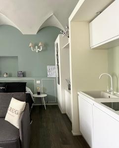 a living room with a couch and a sink at COTTON CANDY TORTELLINOSUITE Modena in Modena +42 photos