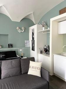 a living room with a couch and a table at COTTON CANDY TORTELLINOSUITE Modena in Modena
