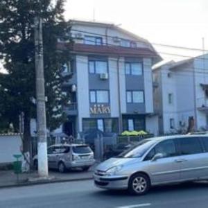 un furgone argentato parcheggiato di fronte a un edificio. di Casa Mary a Eforie Nord