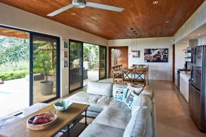 a living room with a couch and a table at Casa Colibri - Stunning ocean view in Santa Teresa Beach