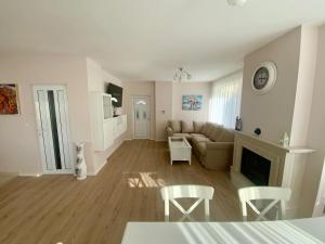 a living room with a couch and a table at Green Village Park in Dobrich