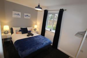 a bedroom with a bed with a teddy bear on it at 4 Bedroom House Near Manchester Airport, Wythenshawe Hospital and Trafford Centre in Wythenshawe