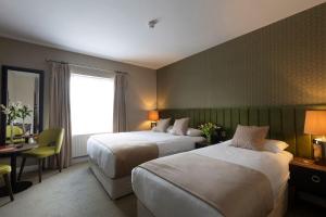 Letto o letti in una camera di Cahir House Hotel