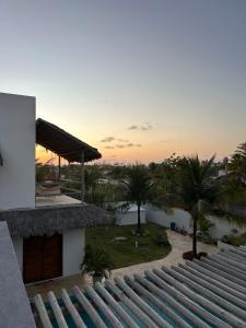 a view of the sunset from the roof of a building at Casa Caiana - Preá in Prea