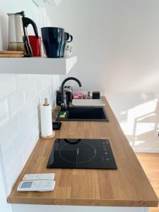 a kitchen counter with a sink and a stove at Quiet, green, relaxing place - 1 bedroom apartment in Balatonfüred