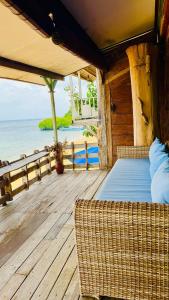 a bed on a deck with a view of the ocean at Fisherman Shack in Nusa Lembongan +6 photos