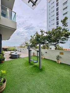 a balcony with green grass and a swing at The Palladium - Modern Executive Studio in Iloilo City +36 photos