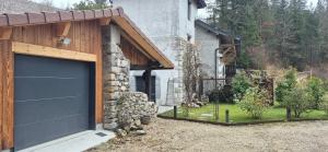 a garage door on the side of a house at Domaine des moulins - La tour et son spa in Villy-le-Bouveret