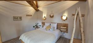 a bedroom with a bed in a room at Domaine des moulins - La tour et son spa in Villy-le-Bouveret