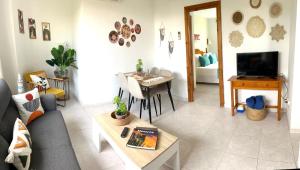 a living room with a couch and a table at Apartamento Forcat 25 in Cala en Forcat