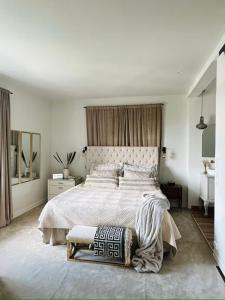 a white bedroom with a large bed and a mirror at Extravagant villa central & by the sea in Oslo