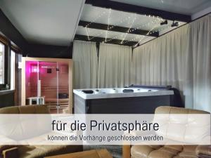 a living room with a tub in the middle of a room at Germersheimer Rhein-Idylle Sauna, Whirlpool in Germersheim +41 photos