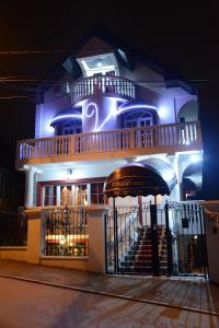 a building with a staircase in front of it at night at Apartmani Vivaldi Niš in Niš
