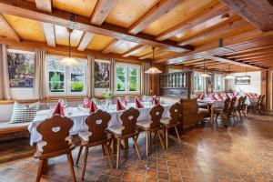 a dining room with long tables and chairs at Gasthaus zur Linde und Fewo in Menzenschwand