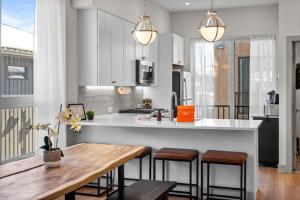 a kitchen with a wooden table and a counter top at ElevateA Rooftop - Silverthorne in Coffeyville