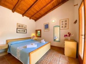 a bedroom with a bed with two teddy bears on it at Villa Lorenza in Baja Sardinia