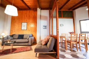a living room with a couch and a table at Tirana Experience, Authentic Stays in the Heart of Old Tirana in Tirana