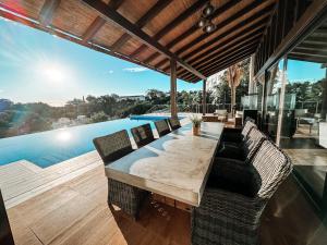 a dining room with a table and chairs and a pool at Luxury Boutique B&B - Villa Prana Marbella in Ojén +28 photos