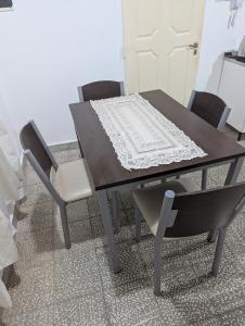 a dining room table with two chairs and a table and chairsuggest at Departamento Achalay in Chilecito