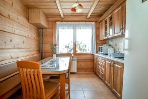 a small kitchen with a table and a window at U Justynki in Małe Ciche