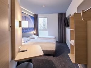 Postel nebo postele na pokoji v ubytování B&B Hotel Köln-Messe + 22 fotografií