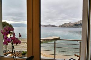 a view of the water from a room with a window at Apartments Barbalic Beach in Baška +70 photos