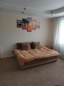 a bedroom with a large bed in a room at Просторі апартаменти на ВДНГ in Kyiv