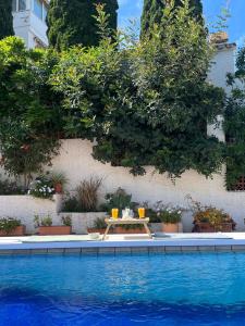a table with drinks on it next to a swimming pool at Villa Mara in Caleta De Velez