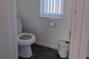 a bathroom with a toilet and a window at Doncaster-House-Sleeps8-Parking-Garden in Doncaster +45 photos