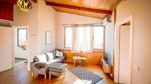 a living room with a couch and a table at Tirana Experience, Authentic Stays in the Heart of Old Tirana in Tirana