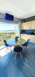 a dining room with a table and two chairs at Hartklop Luxury Self Catering Guesthouse in Linkside