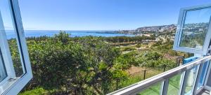 a view of the ocean from the balcony of a house at Hartklop Luxury Self Catering Guesthouse in Linkside