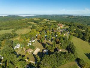an aerial view of a house surrounded by trees at Camping Le Mas de Sireuil in Sireuil