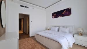 Ένα ή περισσότερα κρεβάτια σε δωμάτιο στο Axxodia- Apartments In Aeon Towers
