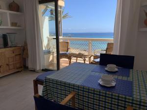 a table and chairs with a view of the ocean at Borras in Es Pujols
