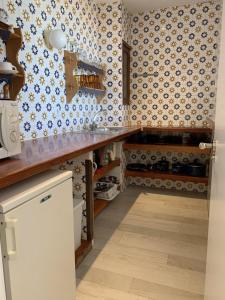 a kitchen with blue and white wallpaper and a counter at Borras in Es Pujols +28 photos