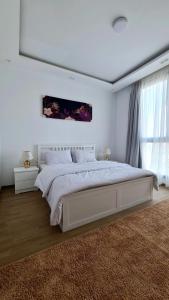 Ένα ή περισσότερα κρεβάτια σε δωμάτιο στο Axxodia- Apartments In Aeon Towers