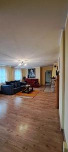 an empty living room with a couch and a table at Apartament Alcatraz 90m z kominkiem Kamienna Góra in Kamienna Góra
