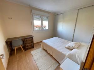 a bedroom with a bed and a desk and a window at Chalet Miracies in Hio +48 photos
