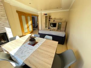 a room with a table and chairs and a bedroom at Chalet Miracies in Hio