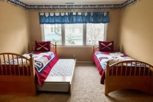 two twin beds in a room with a window at Sea Colony - 56192 Pine Branch in Bethany Beach +54 photos