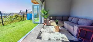 a living room with a couch and a table at Hartklop Luxury Self Catering Guesthouse in Linkside