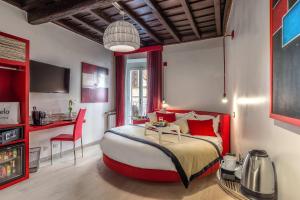 a bedroom with a large bed and a desk in it at Spagna Luxury'n Trevi in Rome