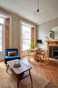 a living room with a blue couch and a table at Georgian House Hotel in London