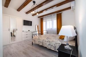 a bedroom with a bed with a lamp on a table at Villa Ivan in Pridraga +25 photos