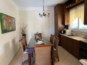 a kitchen with a table and chairs in a kitchen at Sea & Sun Retreat in Nea Vrasna