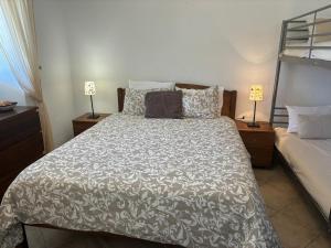 a bedroom with a bed and two lamps on tables at Casa do Campo in Carvoeiro